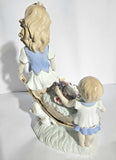 Lladro "style" Porcelaine Figure of 2 girls with Flowers in a wheelbarrow