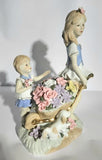 Lladro "style" Porcelaine Figure of 2 girls with Flowers in a wheelbarrow
