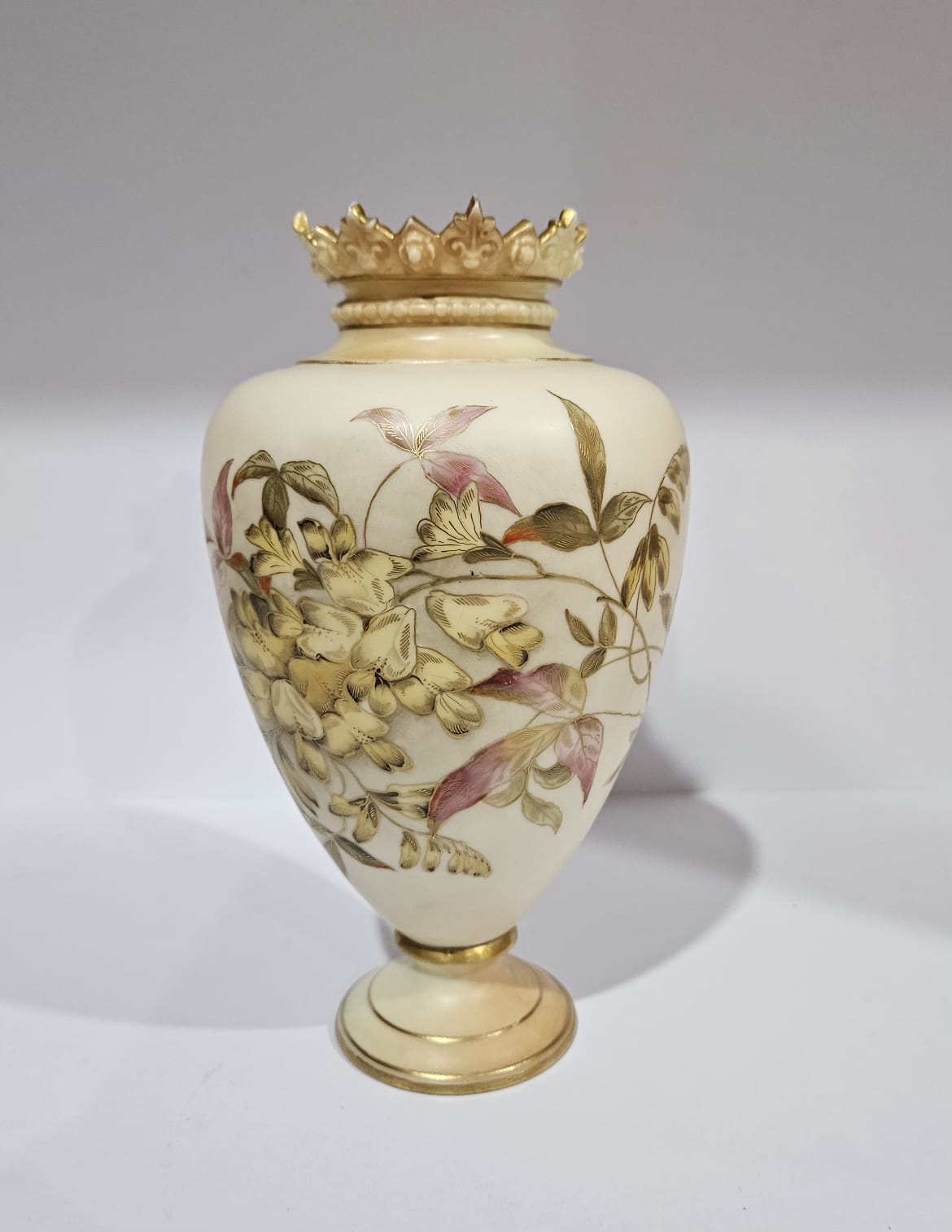 A Royal Worcester blush ivory vase with gilt and floral decoration dat ...