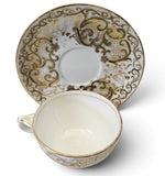 Antique "Vieux Paris" porcelain teacup and saucer w/ raised gold-gilt rococo scroll Circa 1850s
